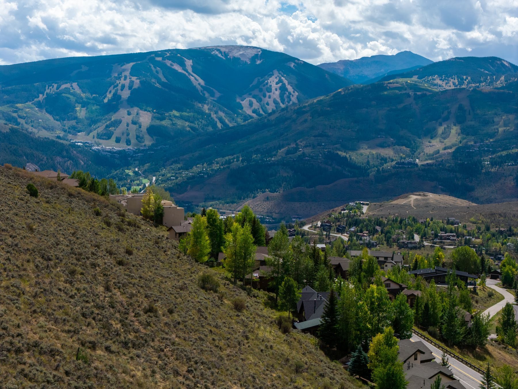 Aerial view of 5780 Wildridge Road East with Beaver Creek ski runs in the distance